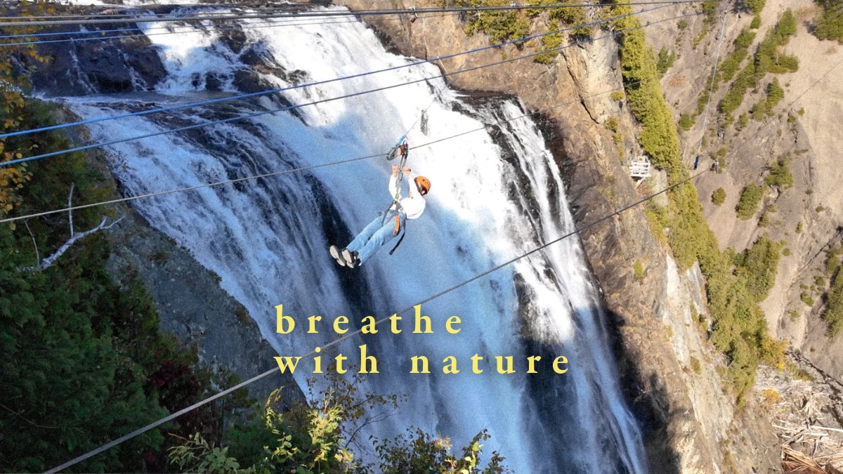 A person ziplining through the mist of a waterfall at Montmorency Falls — blog image for Who Am I? by TOMOKO